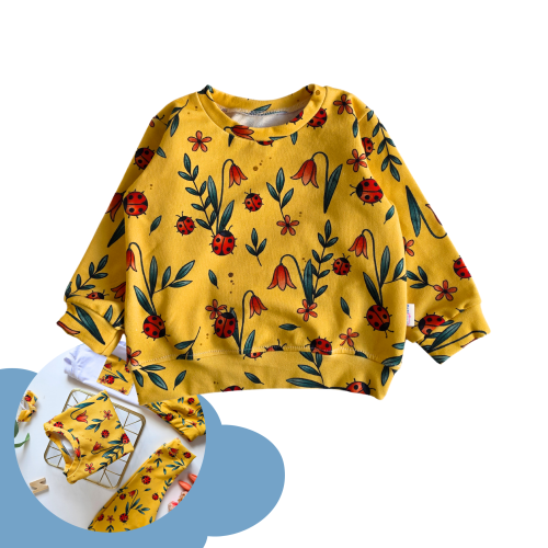 Żółta bluza dziecięca MatiMade w czarne biedronki i czerwone kwiaty na białym tle