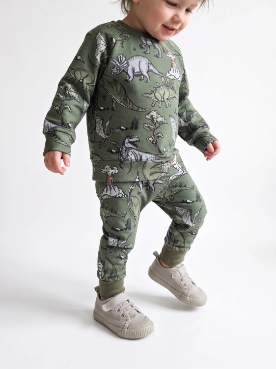 Wzór dinozaurów khaki na dziecięcej dzianinie dresowej